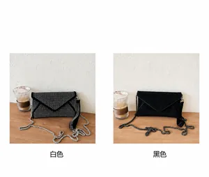 Detail showing two sparkling rhinestone envelope bags in silver and black colors