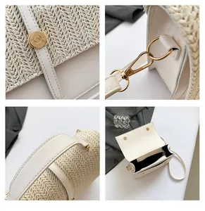 Detail view of woven straw shoulder bag with beige leather trim and gold buckle