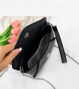 Detail view of the black rhinestone evening bag interior with organized compartments