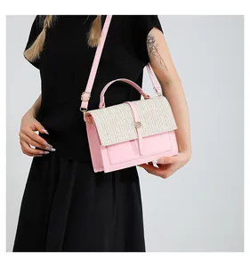 Close-up of pink leather handbag with white woven flap and gold hardware detail
