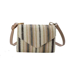 Crossbody bag with multi-color wave weave pattern and adjustable brown strap