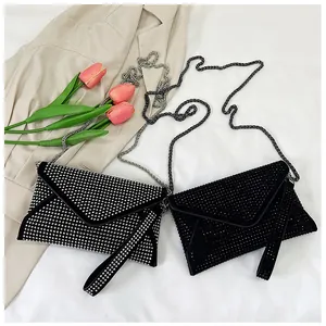 Detailed view of silver and black rhinestone envelope clutch bags with chain straps