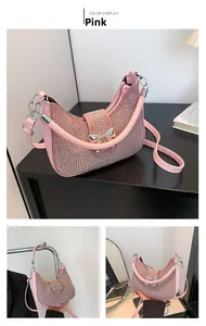 Detailed view of pink rhinestone hobo bag featuring a silver metal bow and shoulder strap