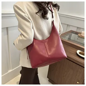 Model wearing a burgundy vintage hobo bag with large capacity and smooth leather finish