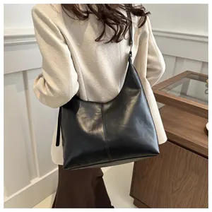 Detail view of large black leather hobo bag showing the seam and soft slouchy design