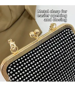 Macro shot of gold vintage engraved hardware clasp on a luxury rhinestone clutch bag