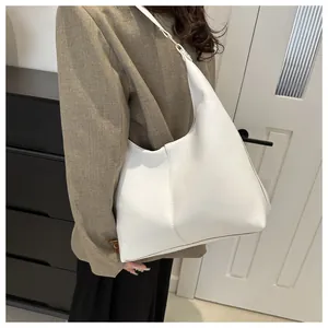 Minimalist white leather hobo bag showing clean texture and shoulder strap detail
