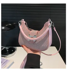 Pink underarm bag detail with silver rhinestones and bow metal buckle closure