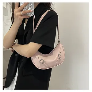Macro detail of glossy pink hobo bag with adjustable buckle straps and silver hardware