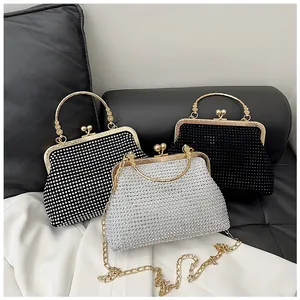 Detailed macro view of rhinestone clutch bags in black and silver with metal chain strap