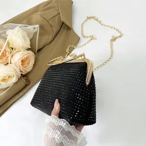 Elegant black rhinestone evening bag with gold metal frame and chain strap handle