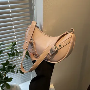 Chic pink crescent saddle bag in PU leather with vintage buckle straps and eyelets