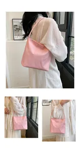 Detail showing the 'pretty and libety' embroidery on this pink nylon tote shoulder bag