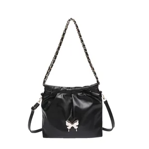 Elegant black soft PU bucket bag with silver butterfly buckle and chain strap