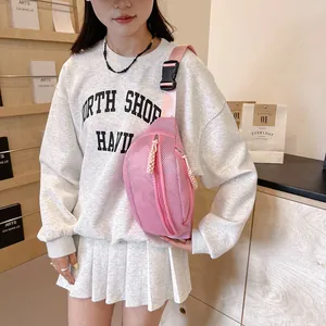 Detailed view of pink mesh chest bag with double zipper and black plastic buckle