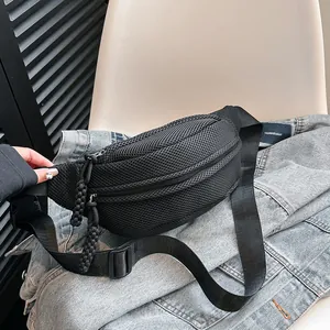 Detail of black mesh cross-body bag featuring breathable honeycomb texture and double zippers