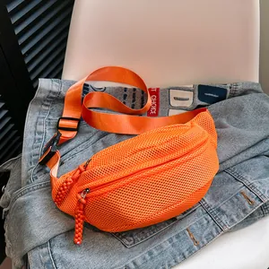 Close-up of orange mesh belt bag featuring dual zippered pockets and woven pull cords