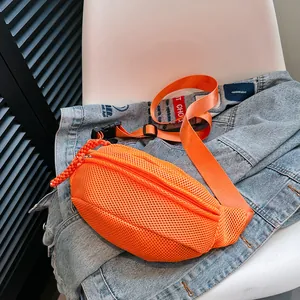 Detail of orange mesh crossbody bag featuring breathable fabric and durable plastic buckle