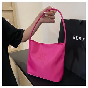 Detail of hot pink nylon tote bag featuring exquisite pretty and liberty embroidery