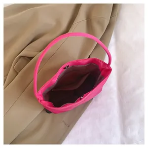 Interior view of the hot pink nylon bag featuring a zipper pocket and magnetic snap closure