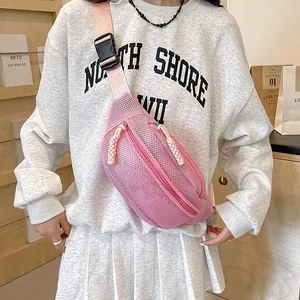 Pink mesh crossbody chest bag worn by model with adjustable strap and casual sporty style
