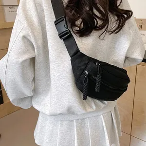 Black mesh crossbody chest bag for women, breathable sporty waist pack on person