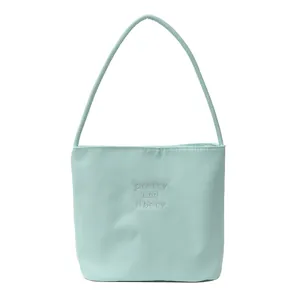 Light blue nylon handbag with white embroidery and slender shoulder straps