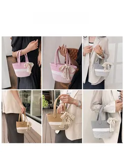 Detail view of woven cotton rope bucket bag with lace bow and colorful striped texture