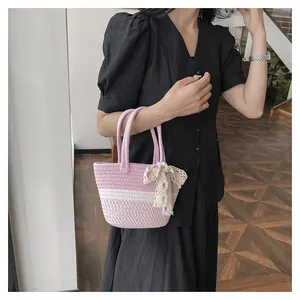 Handwoven pink and white cotton rope bag with a delicate beige lace bow detail