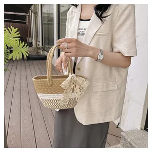 Detail of hand-woven basket bag with lace bow and bicolor khaki cotton rope texture
