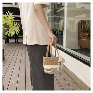 Detail of hand-woven straw bag featuring delicate lace bow and textured fiber stitch