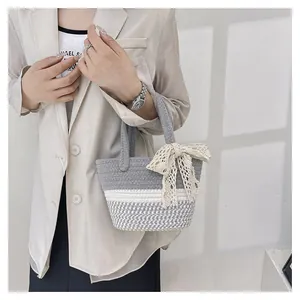 Detail of hand-woven cotton rope bag featuring a lace bow and three-tone color block design