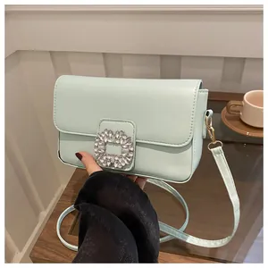 Minimalist mint green square crossbody bag with sparkling rhinestone buckle closure