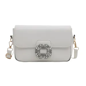White minimalist square crossbody bag featuring a large silver rhinestone buckle and PU leather