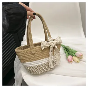 Close-up of woven straw handbag with a large white lace bow detail on a chair