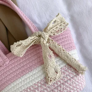 Pink and white woven cotton tote bag with delicate lace bow for beach vacations