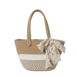 Handwoven straw tote bag with lace bow decoration for summer beach vacations