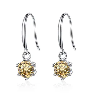 Detail of six-prong setting with yellow round-cut moissanite stone on silver hook earrings