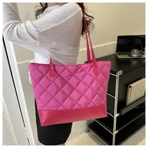 Detailed side view of rose red quilted tote bag styled with casual white top and black skirt