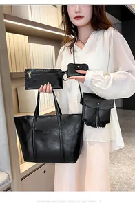 Detail of 4-piece black faux leather handbag set featuring a large tote and gold hardware