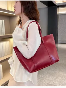 Close-up of wine red faux leather tote bag showing high-quality lychee grain texture