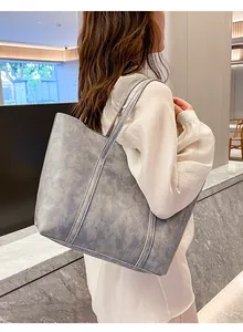 Detail of grey marble textured faux leather tote bag with long shoulder strap handles