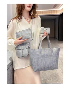 Detail of 4-piece grey-blue tote bag set featuring stylish marble texture and tassel charm