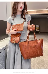 Detail of a 4-piece vintage brown faux leather handbag set with tote and shoulder bag