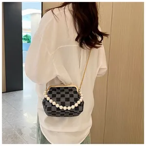 Detailed back view of a checkerboard pattern shell bag with pearl handle and chain
