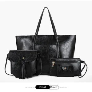 Detail view of black 4-in-1 handbag set featuring vintage texture and tassel accents