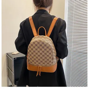 Mini brown checkerboard backpack shown on model for size and style perspective