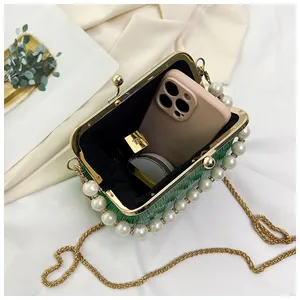 Interior view of green pleated shell bag showing capacity for phone and cosmetics