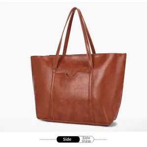 Side view of caramel brown vintage tote bag with retro faux leather texture and pocket