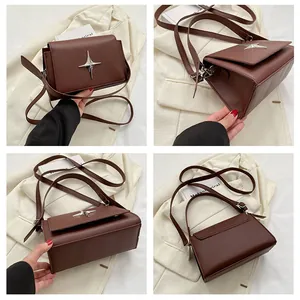 Dettagli della borsa a tracolla in pelle marrone vintage con emblema a stella argento